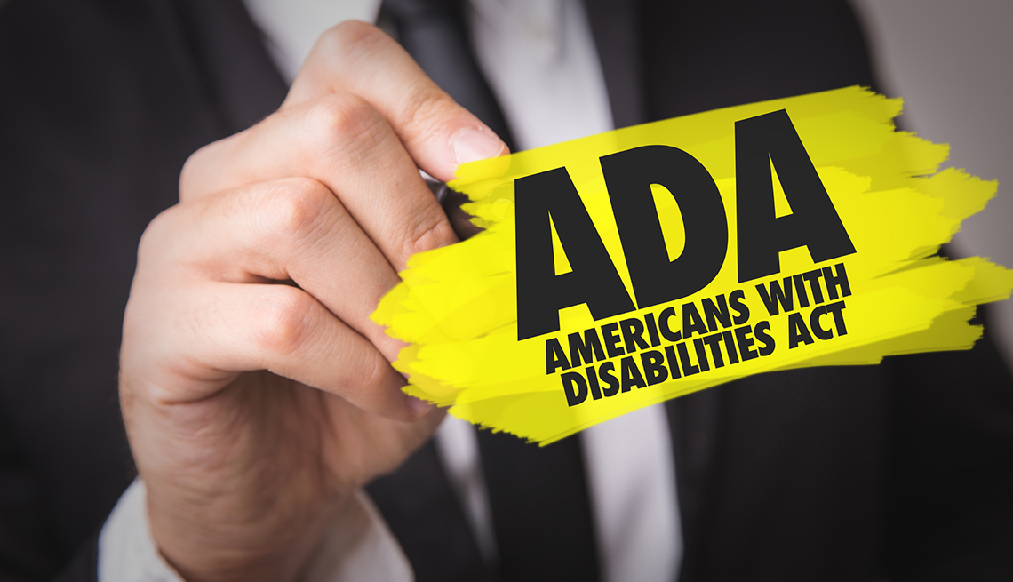 man holding a paper that says A D A americans withe disabilities act